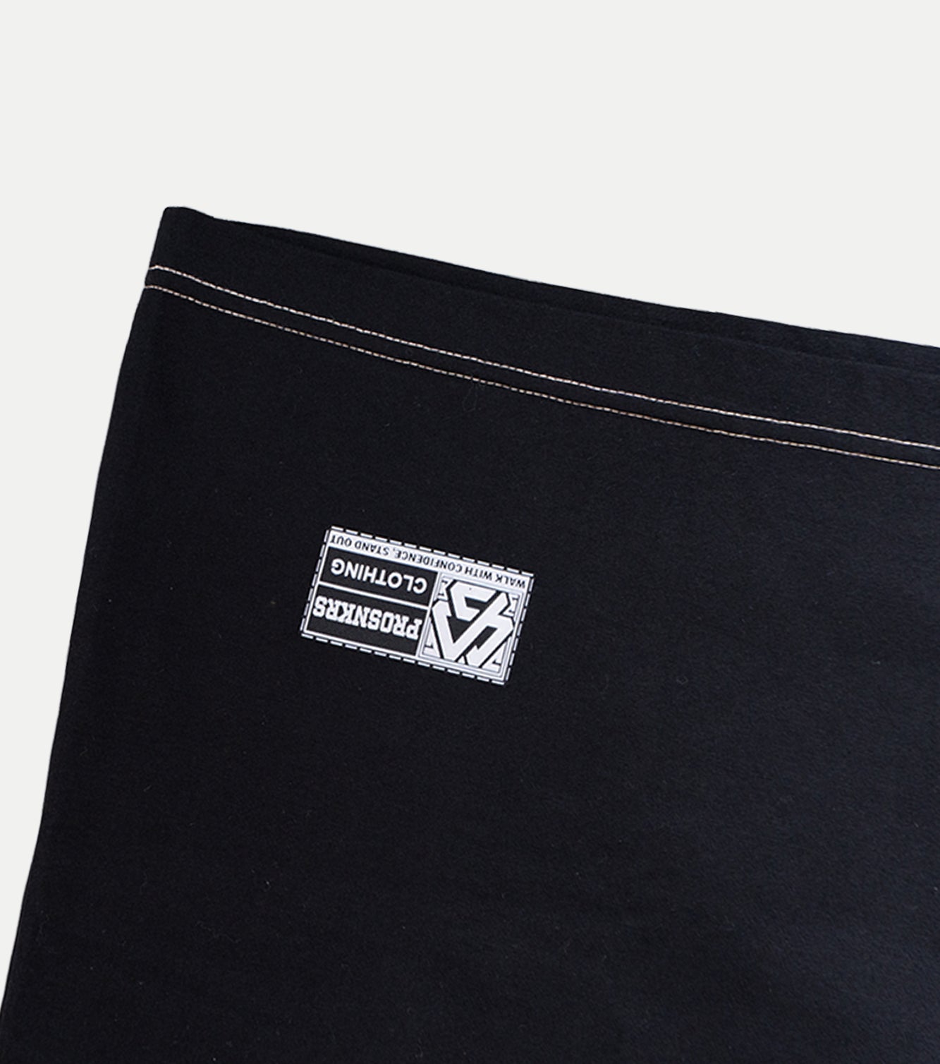 Black fabric with a white label on a light gray background